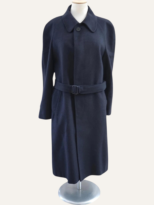Navy blue coat on a mannequin against a white background