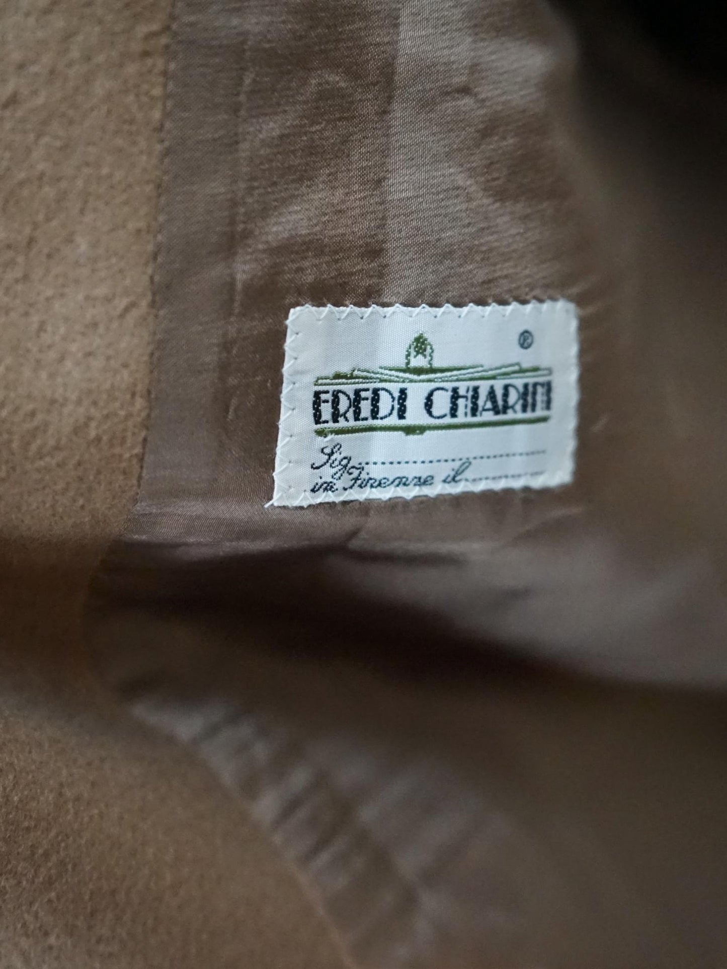 Close-up of a brown fabric with a brand label on it.