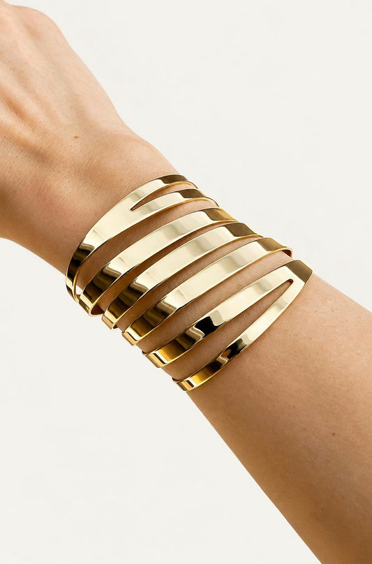 Thierry Mugler gold-tone cuff worn on the wrist
