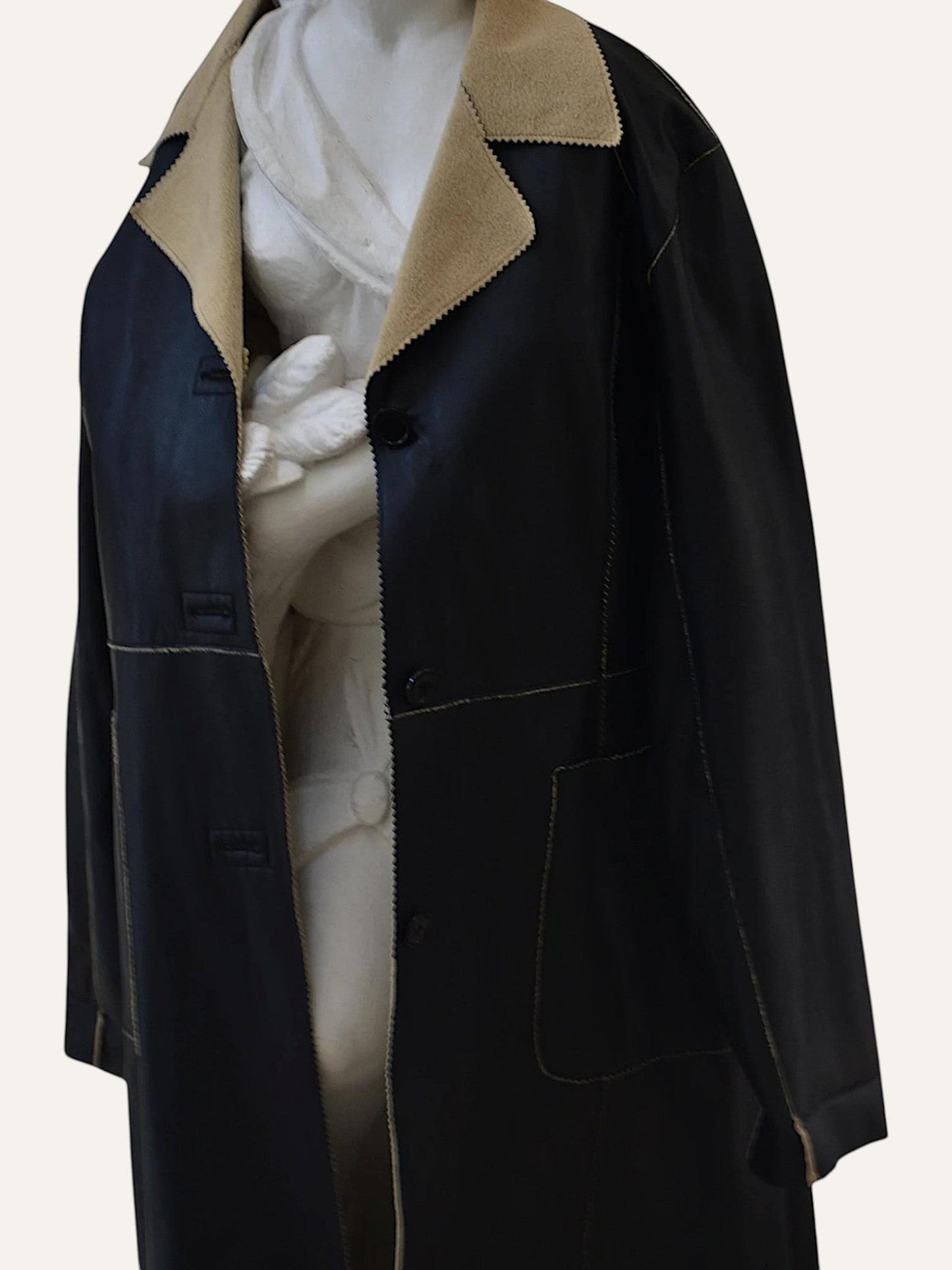 Anemoia Vestiaire black longline faux leather coat with tan collar and detailed stitching.