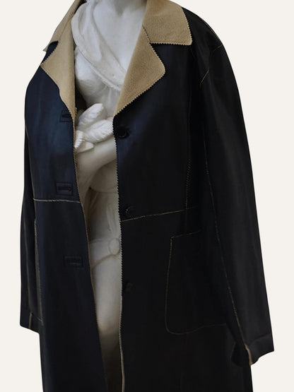 Anemoia Vestiaire black longline faux leather coat with tan collar and detailed stitching.