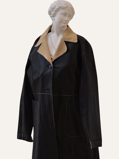 Anemoia Vestiaire black faux leather longline coat with tan collar, detailed stitching, and front pockets.