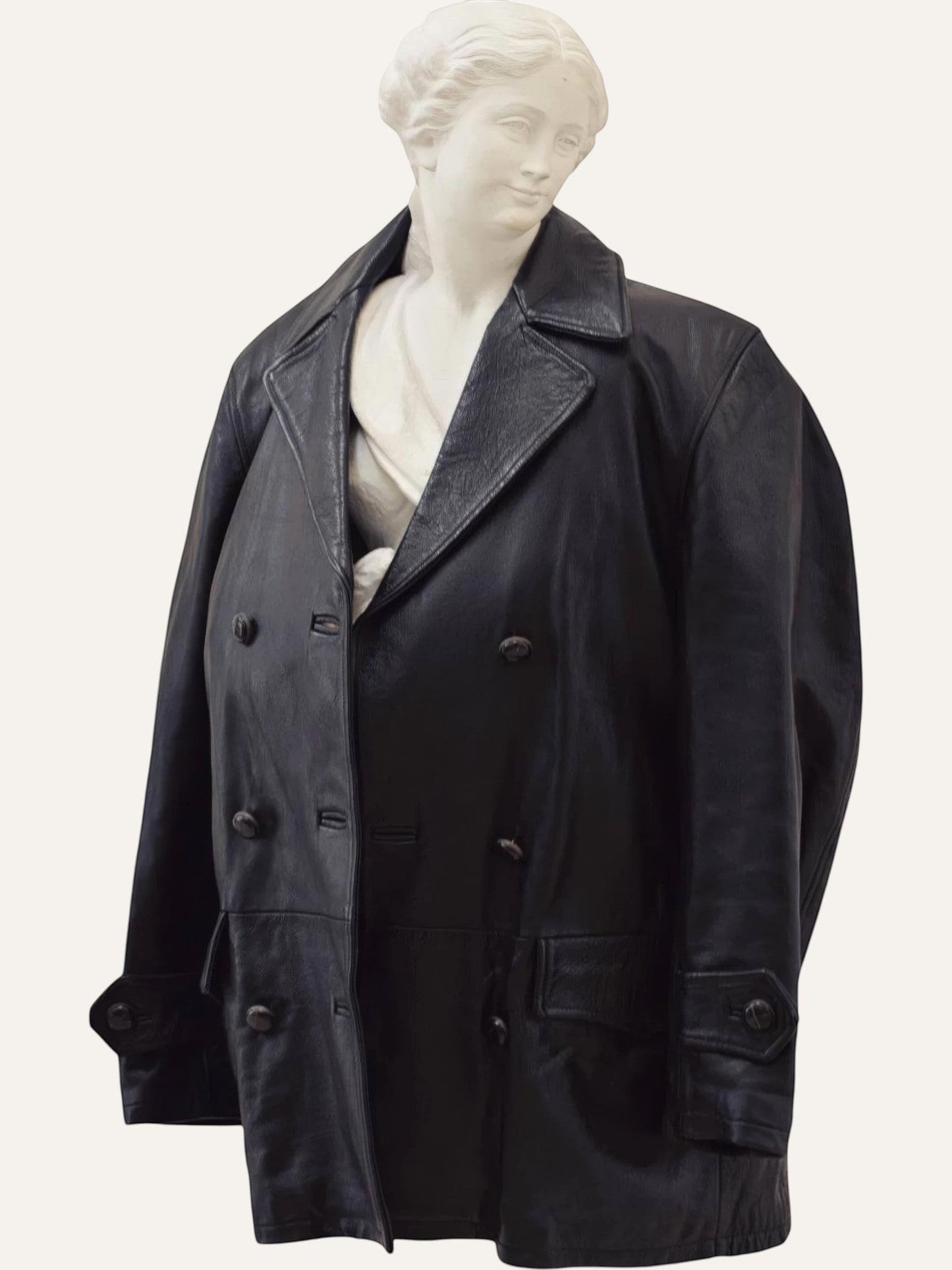 Anemoia Vestiaire black genuine leather mid-length trench coat with double-breasted button closure and notched lapels.