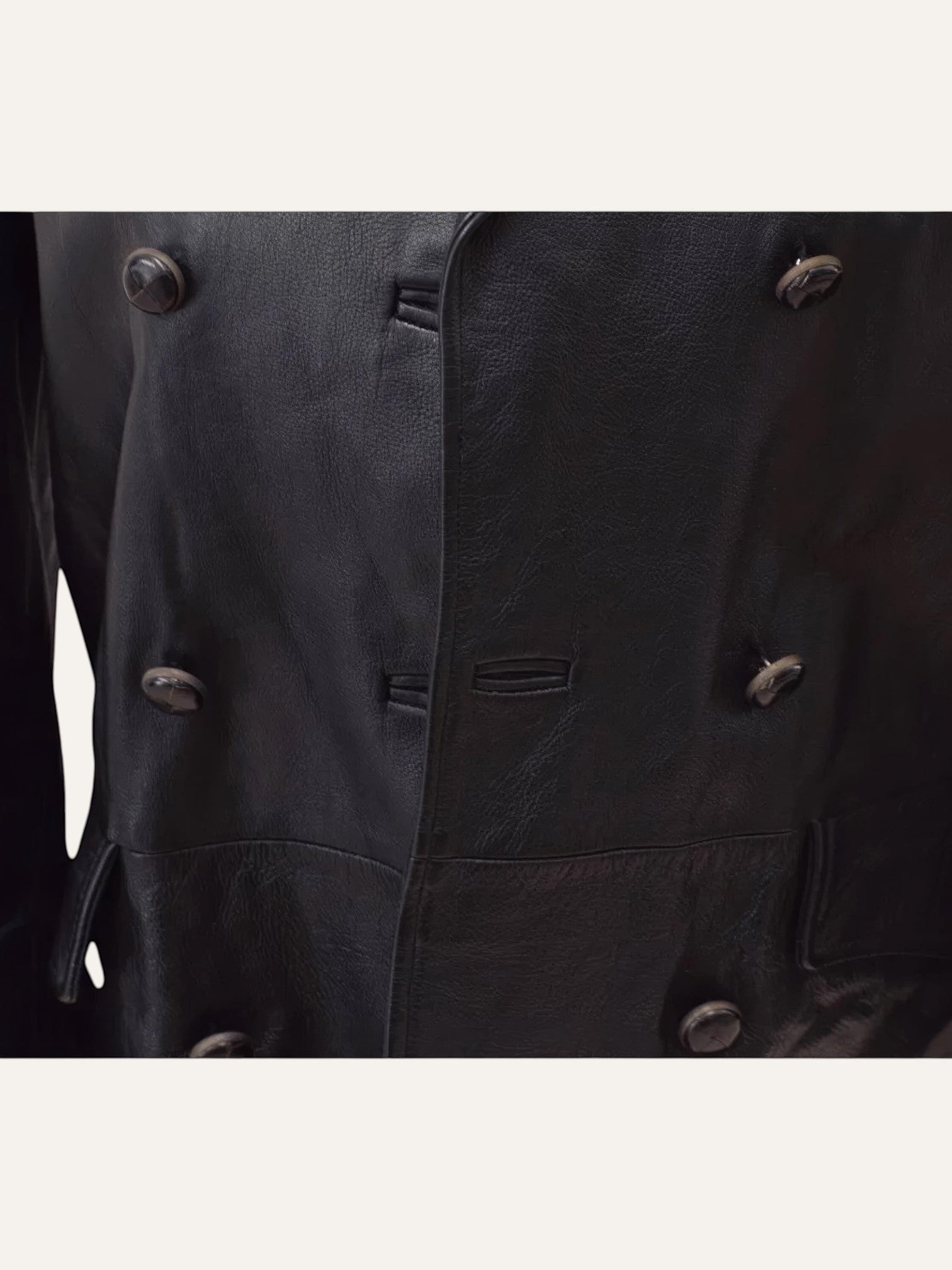 Anemoia Vestiaire black genuine leather trench coat with double-breasted button closure and vintage detailing.