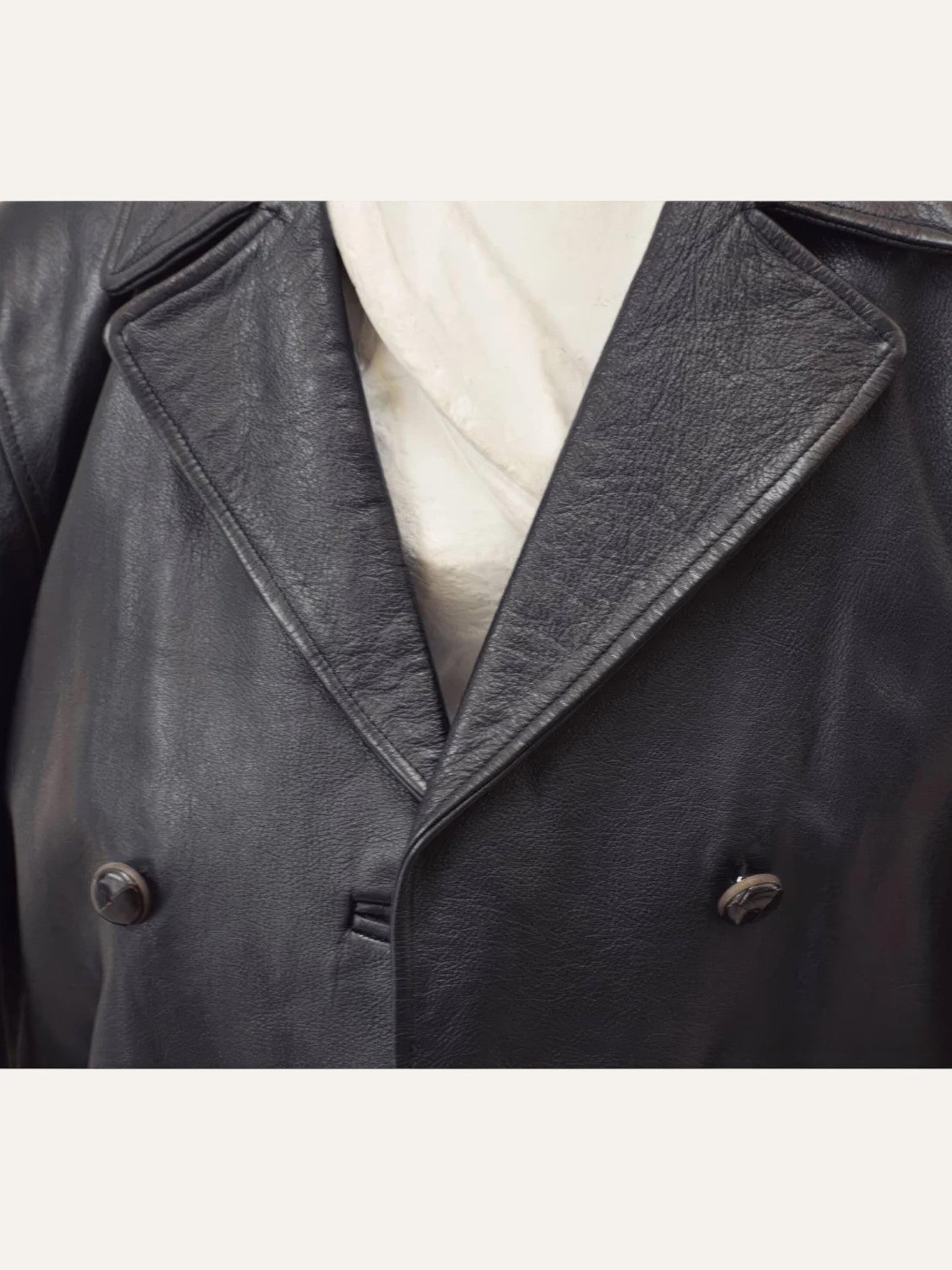 Anemoia Vestiaire black genuine leather trench coat with double-breasted button closure and classic collar.