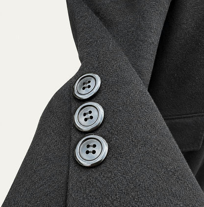Notched lapel and three-button cuff detail of the cashmere overcoat