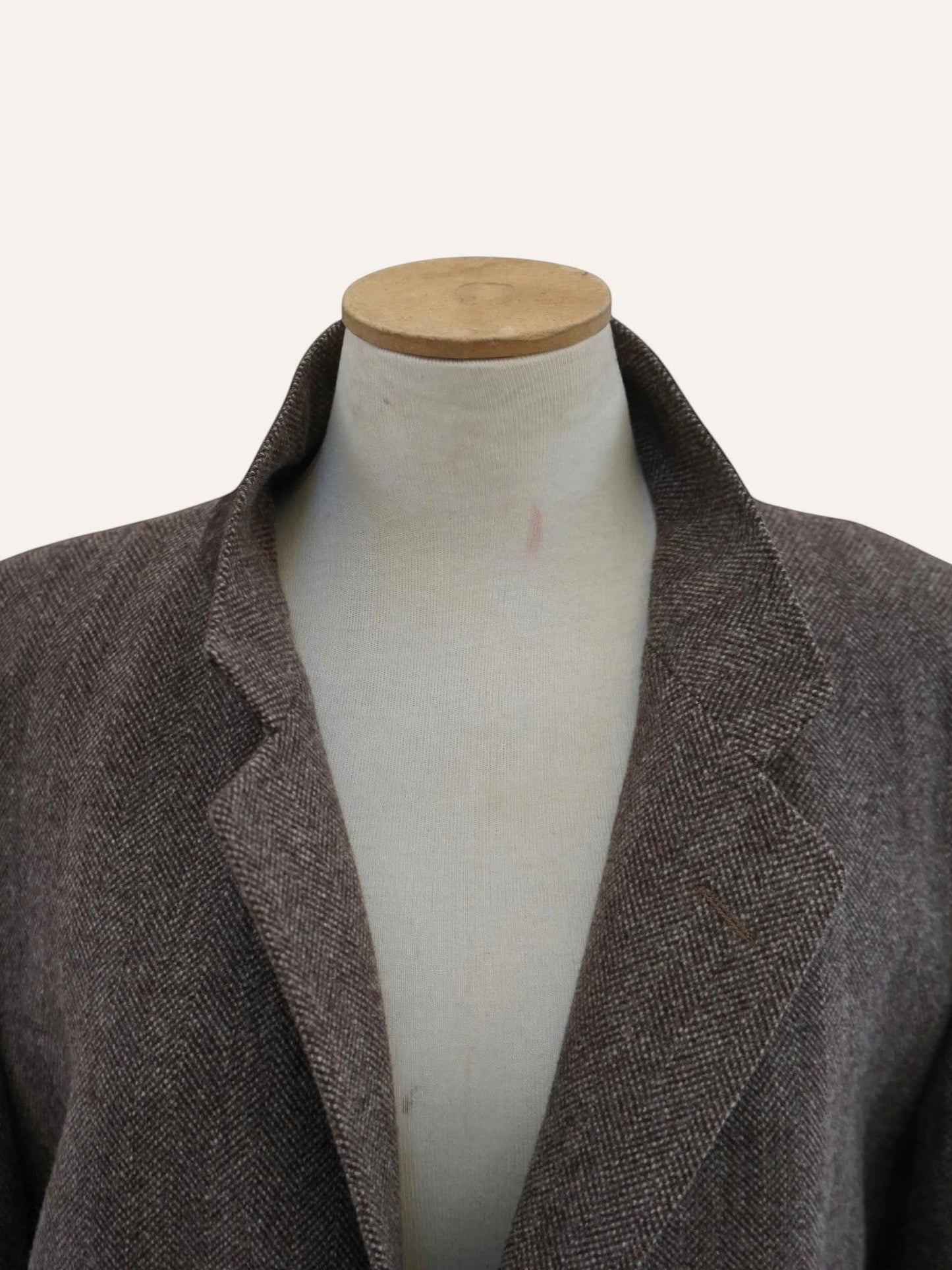 Brown blazer on a mannequin against a white background