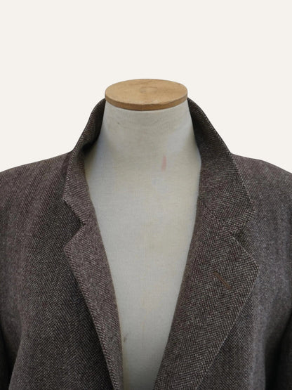 Brown blazer on a mannequin against a white background