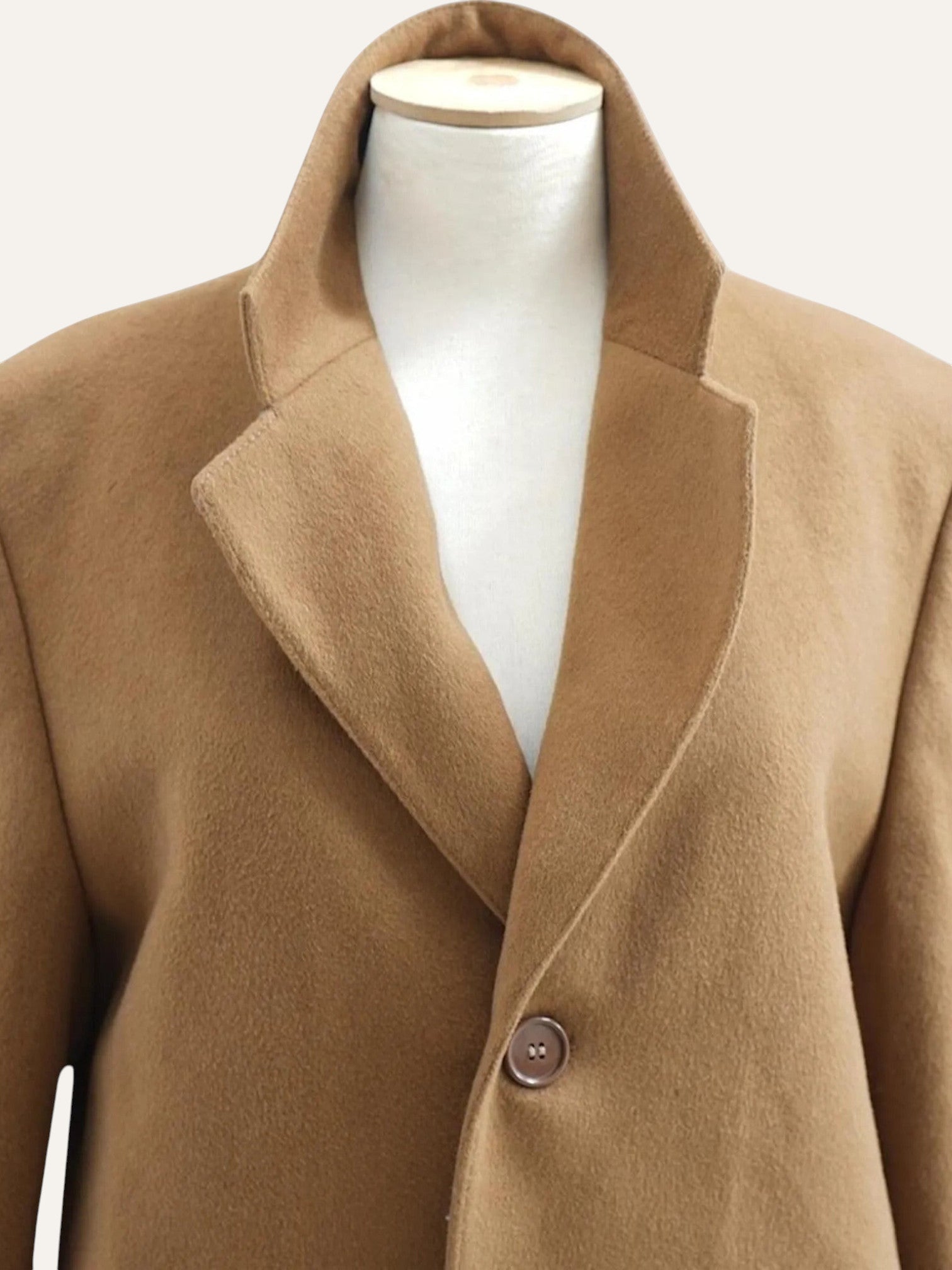 Brown coat on a mannequin against a white background