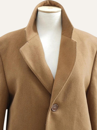 Brown coat on a mannequin against a white background