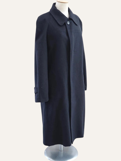 Navy blue coat on a mannequin against a white background