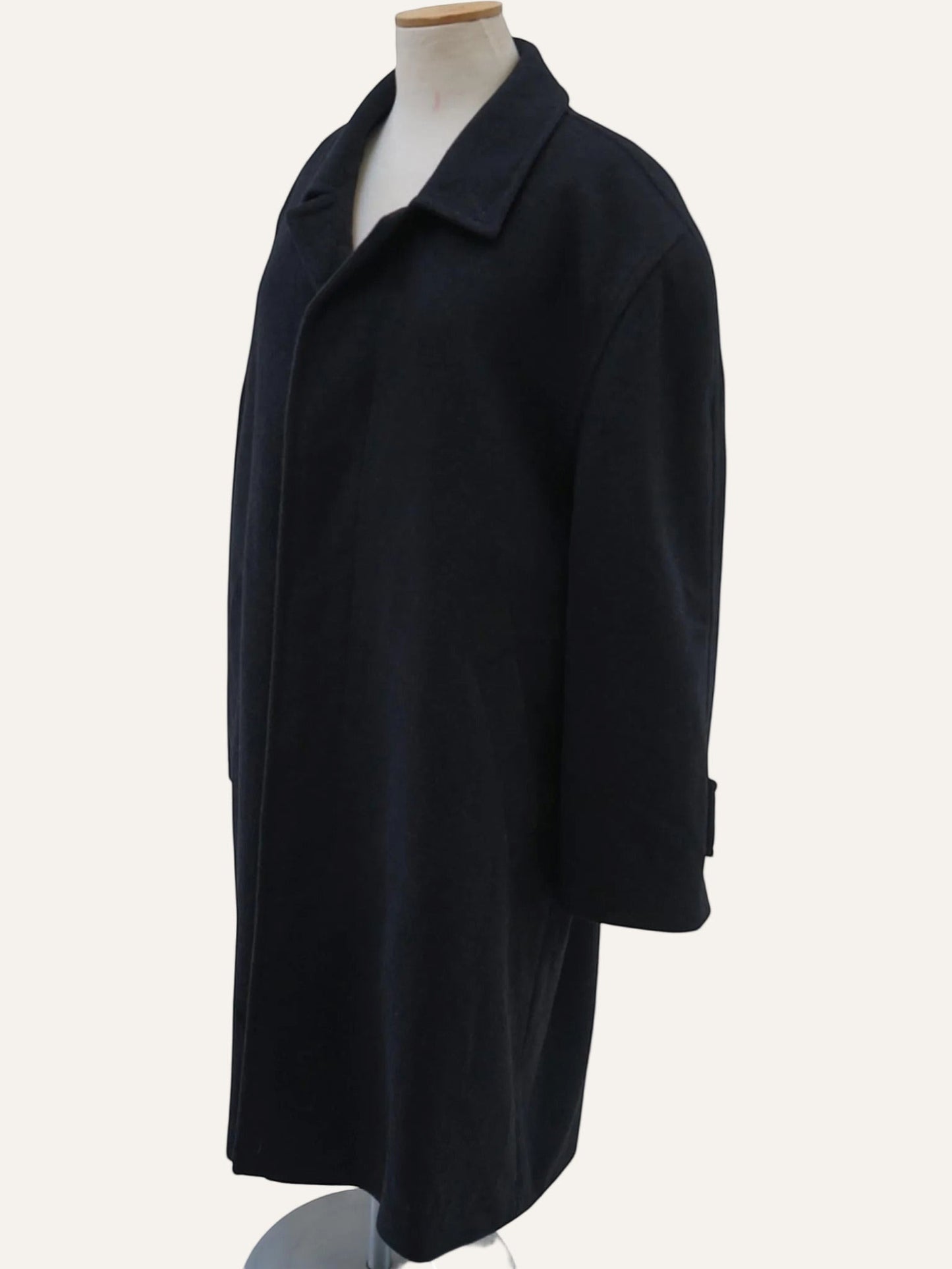 Black coat on a mannequin against a white background