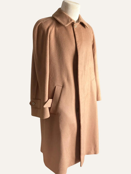Brown coat on a mannequin against a white background