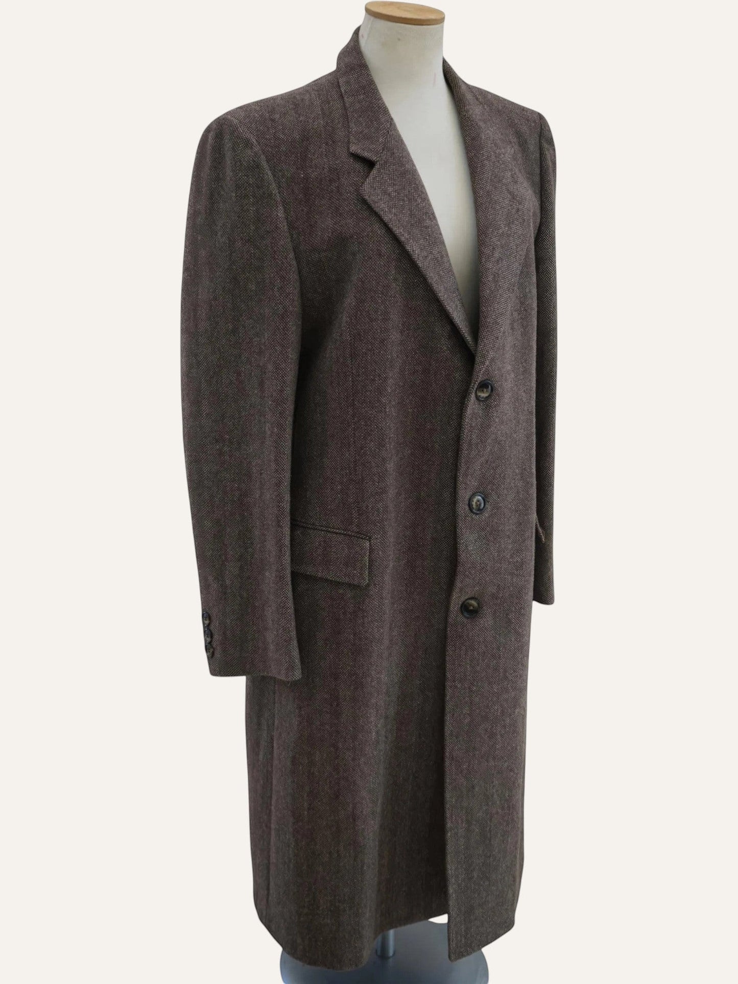 Brown overcoat on a mannequin against a white background