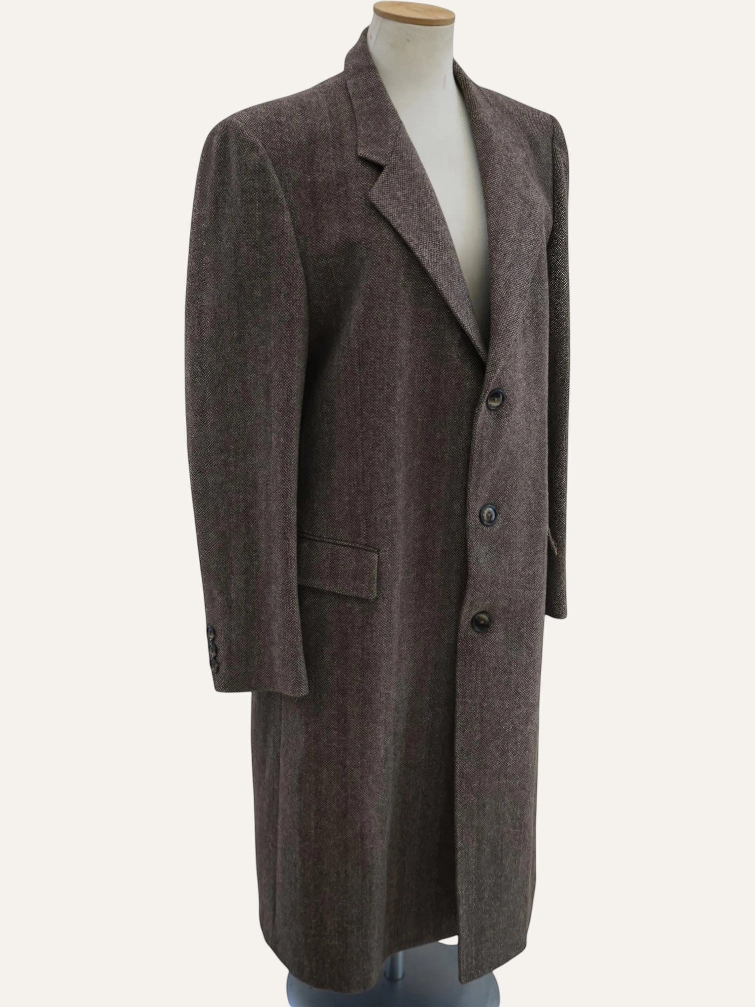 Brown overcoat on a mannequin against a white background